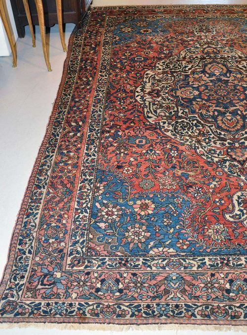 BACHTIAR old.Blue and white central medallion on a rust coloured ground with blue corner motifs, the entire carpet is opulently patterned with colourful trailing flowers, triple stepped border in pink and white, good condition, 225x305 cm.