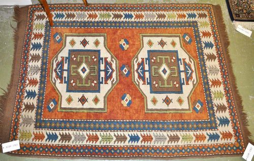 KARS KAZAK old.Rust coloured ground with two white medallions, geometrically patterned, white border, slight wear, 120x165 cm.