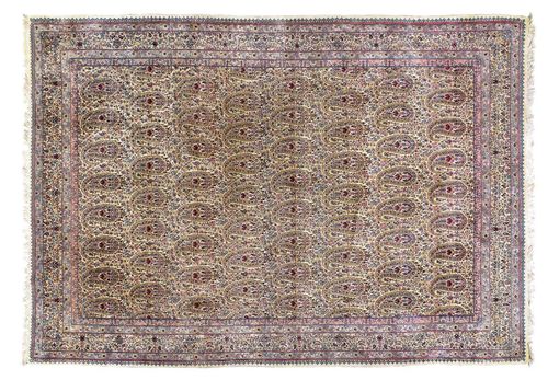 KIRMAN old. Beige ground, patterned throughout with boteh motifs in delicate pastel colours, beige border, good condition, 350x245 cm.