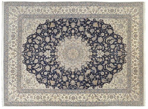 NAIN.White central medallion on a blue ground with white corner motifs, the entire carpet is finely patterned with trailing flowers and palmettes, white border, good condition, 295x405 cm.