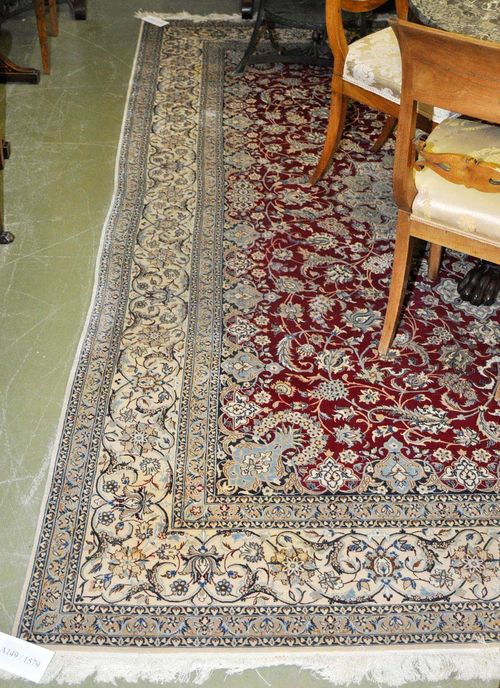 NAIN.Red central field with a beige central medallion, the entire carpet is finely patterned with trailing flowers and palmettes, white border, good condition, 210x317 cm.