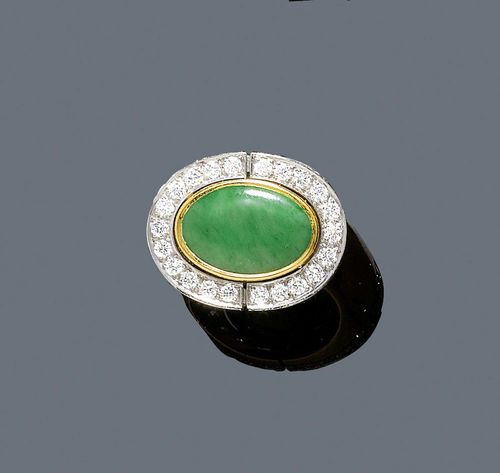 JADEITE AND DIAMOND RING, PÉCLARD. Yellow and white gold 750. Casual-elegant ring, the top set with 1 oval jadeite cabochon of 3.34 ct, the setting encrusted with 48 brilliant-cut diamonds weighing 1.23 ct. Size 48. With case and copy of invoice,  1977.