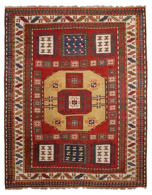 KARATCHOPH antique.Red central field, geometrically patterned with seven medallions, white wine glass border, restored, good condition, 235x190 cm.