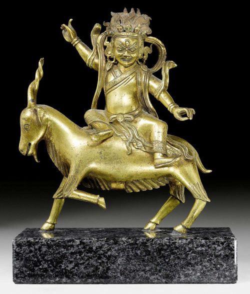 A GILT BRONZE FIGURE OF DAMCAN RIDING ON A GOAT. Tibeto-chinese, 18th c. Height 15.5 cm.