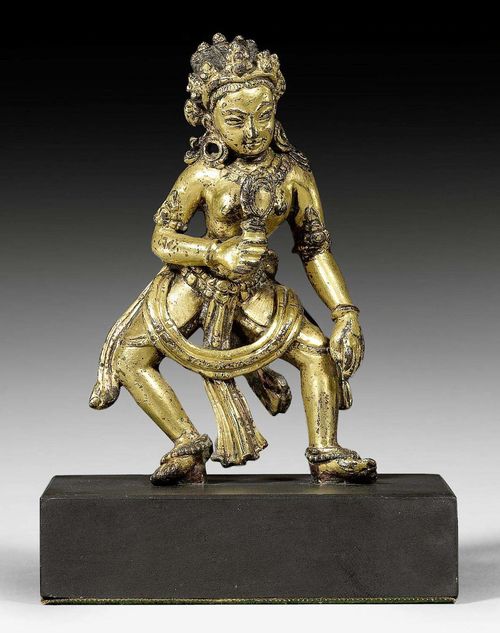 A CHARMING GILT COPPER ALLOY MINIATURE FIGURE OF A FEMALE DEITY, POSSIBLY ADARSHI. Tibet, 15th/16th c. Height 8 cm.
