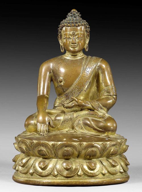 A COPPER ALLOY FIGURE OF BUDDHA SHAKYAMUNI WITH REMAINS OF GILT. Tibet, 16th c. Height 13.2 cm.