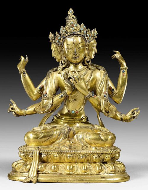 A GILT BRONZE FIGURE OF A SIX ARMED FEMALE DEITY WITH THREE HEADS. Tibetochinese, 18th c. Height 18 cm.
