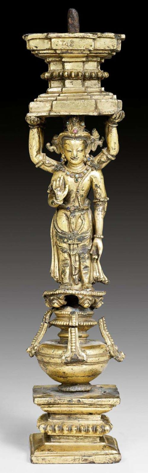 A GILT BRONZE SUPPORT WITH TWO STANDING FIGURES. Nepalese work in Tibet, 14/15th c. Height 34.5 cm. Possibly from Densatil Monastery. Slightly damaged.