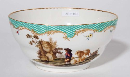 BOWL WITH BUCOLIC SCENE, Meissen, circa 1770.Two scenes with shepherds under a green mosaic border with gold rocaille. The inside with floral bouquet and 'dentil d'or' border. D 19.5cm.