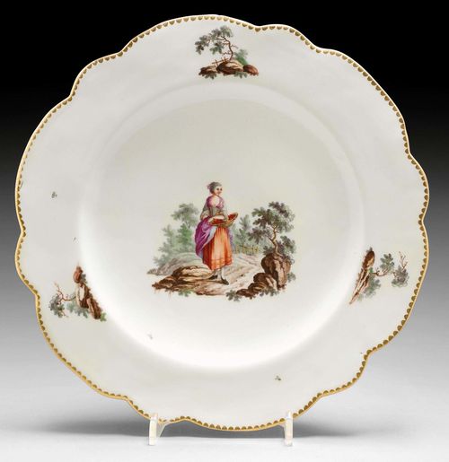 PLATE WITH LANDSCAPE PAINTING AND 'LARGE FIGURE' DECORATION, ZURICH, CIRCA 1770-80.Underglaze blue mark, impressed mark K I. D 24 cm. Provenance: E. Caviglia, Lugano, 2000. Comparable piece: Ducret I, ill.99, 100.