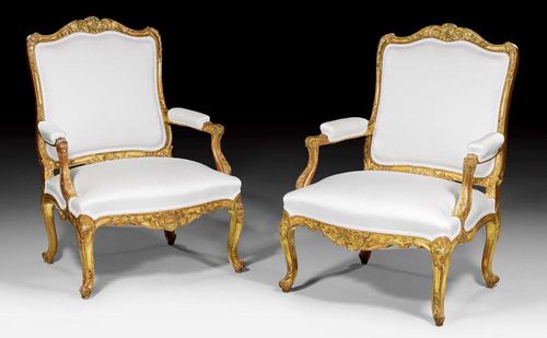PAIR OF FAUTEUILS "A LA REINE",Louis XV style, Germany  circa 1900. Richly carved fauteuils with flowers, leaves and frieze, also painted in gold. With light beige silk covers. 75x52x46x101 cm. Provenance: from an important German private collection.