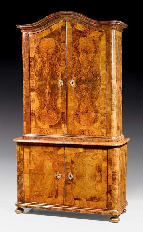 CABINET,Baroque, Basel circa 1730/40. Walnut and burlwood veneer inlaid with reserves and fillets. With gilt bronze mounts. 125x51x230 cm.