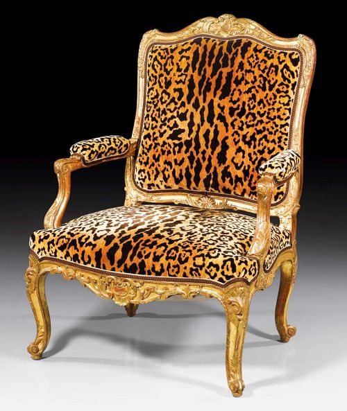 FAUTEUIL "A LA REINE",Louis XV style, Germany  circa 1900. Richly carved gold painted wood with flowers, leaves, cartouches and frieze. With velour covers with leopard pattern. 75x52x46x101 cm. Provenance: from an important German private collection.