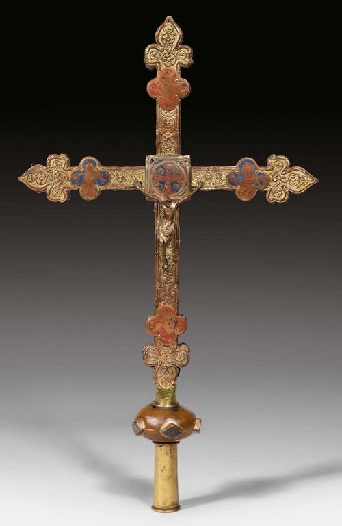 PROCESSIONAL CROSS,probably Upper-Rhine, circa 1300. Wooden core mounted with chased and gilt copper. With champleve plaques depicting the symbols of the Evangelists and similar center plaque as nimbus. Cast bronze Christ with remains of gilding. Verso also with copper mounting, the ends with four chased copper quatrefoils depicting the Evangelists' symbols. Bronze figure of Mary at the center. Node at lower end of the cross with 5  enamel filled rhombuses. H 63, W 38 cm. Heavily restored and varnished. Some losses. The bronze figures and enamel plaques probably non-matching.