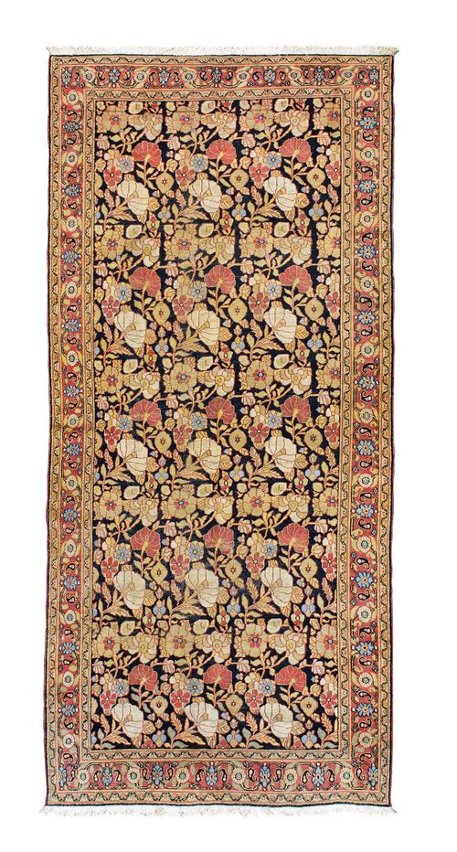 DOROSH antique.Black central field patterned throughout with floral motifs in delicate pastel colours, red border, slight wear, 140x316 cm.