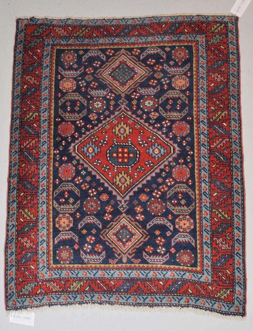 KARS KAZAK old.Blue ground with a red central medallion, geometrically patterned, red border, slight wear, 114x134 cm.