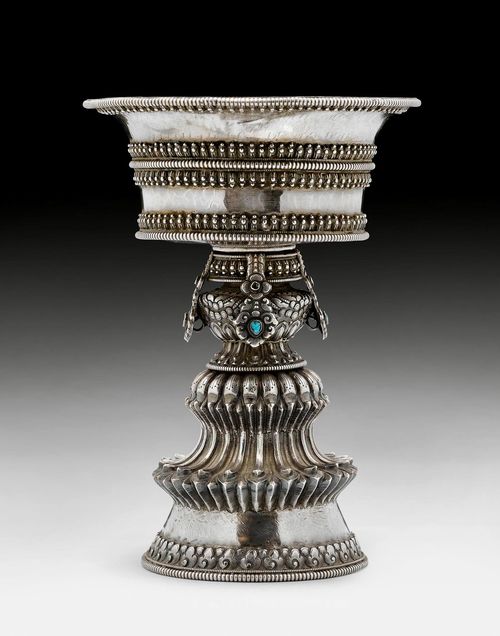 A FINELY CHASED REPOUSSE SILVER BUTTER LAMP. Tibet, 19th/20th c. Height 20.5 cm.