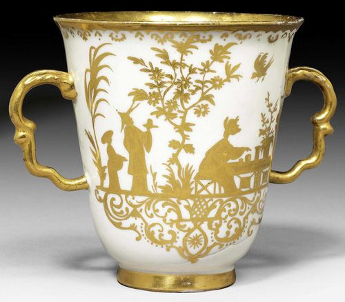CHOCOLATE CUP WITH GOLD CHINESE FIGURES, MEISSEN, CIRCA 1720-24.Painted in Augsburg in the Seuter workshop. Decorated with two Chinese figures at a tea ceremony. Also with flowering bushes and phoenixes in flight. The edge decorated with an Augsburg border Remains of a lustre mark Bc. H 8cm. Restored.