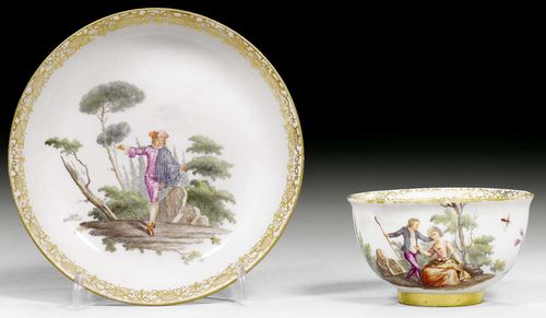 CUP AND SAUCER, MEISSEN, CIRCA 1740.Painted with elegant figures in park landscape in the style of Watteau, the saucer with Beltrame from the Commedia dell'Arte and with landscape scenes. Additionally decorated with scattered insects and Holzschnittblumen. Underglaze blue sword mark, gold numbers 39 on both pieces, impressed numbers.