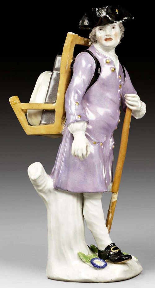 FIGURE OF A BARROW BOY, MEISSEN, CIRCA 1738.Model by J.J. Kändler. Dressed in violet coat with gold buttons, bearing a XX. Underglaze blue sword mark on the back of the plinth. H 18,2cm. Minor chips, old restorations to the walking stick and barrow. Provenance: Private collection, Switzerland