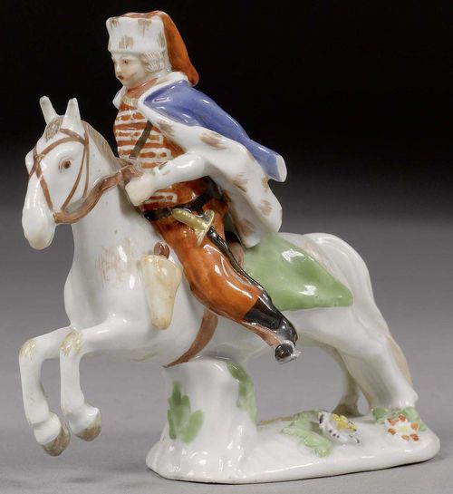MINIATURE GROUP OF A HUSAR ON HORSEBACK IN THE STYLE OF MEISSEN, CIRCA 1750.Set on a flat plinth with applied flowers and leaves. H 8.5cm. Chipped. Provenance: - Private collection, Hamburg. - Via inheritance to a private collection in South Germany