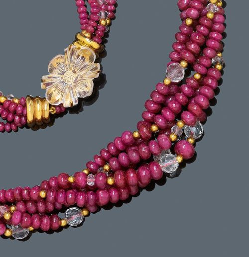 RUBY, ROCK CRYSTAL AND GOLD  NECKLACE. Yellow gold 750. Casual, decorative five-row necklace of numerous graduated ruby rondelles of ca. 3.2 to 7.5 mm Ø weighing ca. 300 ct, additionally decorated with numerous facetted rock crystal beads and gold intermediate links. Clasp decorated with an engraved rock crystal flower set in gold. Signed Regine S., Geneva. L ca. 53 cm.