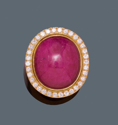 RUBY AND DIAMOND RING , BOUCHERON. Yellow gold 750, 36g. Fancy, solid ring, the top set with a ruby cabochon, treated, of ca. 40.00 ct, signs of wear, within a border of diamonds weighing ca. 1.00 ct. Size ca. 63. From the heirs of Baron Anton Kiss (1880-1970), son of Katharina Schratt, Schloss Mondsee.