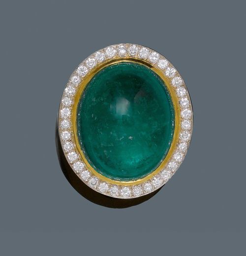 EMERALD AND DIAMOND RING,  BOUCHERON. Yellow gold 750, 53g. Fancy, solid ring, the top set with a Columbian emerald cabochon, treated, of ca. 72.00 ct, signs of wear, within a border of 37 brilliant-cut diamonds weighing ca. 1.50 ct, in white gold 585. Size ca. 64. Includes Gemlab Report 2183/09. From the heirs of Baron Anton Kiss (1880-1970), son of Katharina Schratt, Schloss Mondsee.