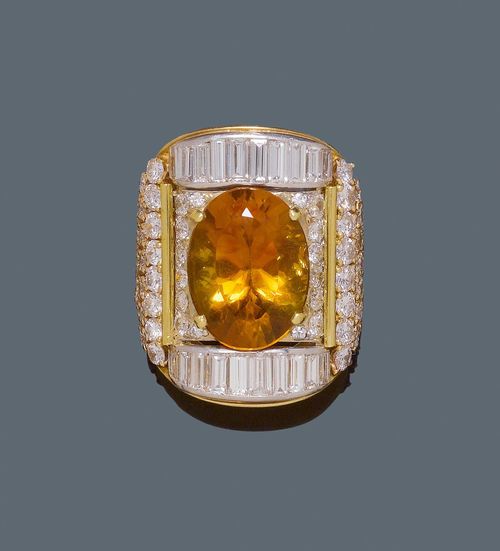CITRINE AND DIAMOND RING. Yellow and white gold 750. Very fancy, large ring, the convex top set with an oval citrine of ca. 15.00 ct, within a border of 20 baguette-cut diamonds weighing ca. 2.50 ct and set throughout with ca. 88 brilliant-cut diamonds weighing ca. 7.00 ct. Size ca. 55. From the heirs of Baron Anton Kiss (1880-1970), son of Katharina Schratt, Schloss Mondsee.
