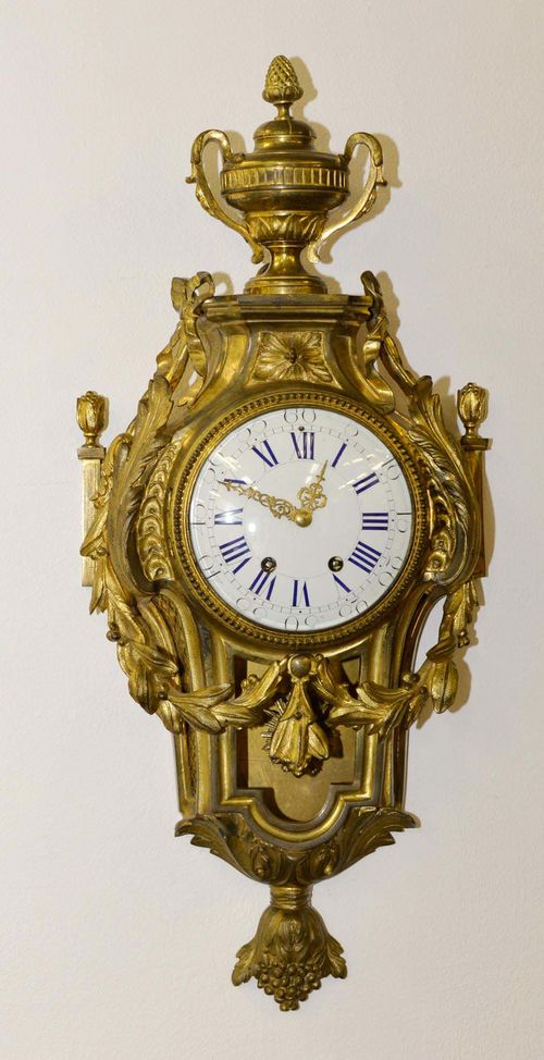 CARTEL CLOCK,in the Louis XVI style, France, 19th century. Gilt bronze. White enamel dial. Paris movement with 1/2-hour strike on bell. H 70 cm. Key missing.