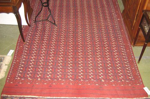 BOCHARA KELIM antique.Interesting piece in good condition. Rust coloured ground, geometrically patterned in blue and white, 360x190 cm.