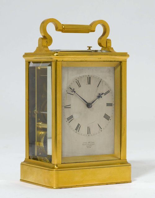 TRAVEL CLOCK WITH CASE, England, early 19th century. The dial signed "JAMES MC CABE ROYAL EXCHANGE LONDON 3354". Brass case, glazed on all sides. Silver-plated and engraved dial. Movement with balance and endless pinion winding. Hour- strike on gong, can be turned off. Repetition on demand. H 18 cm.