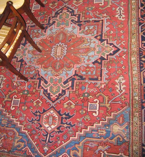 HERIZ antique.Red ground with a central medallion, typically patterned, black border, slight wear, 305x230 cm.