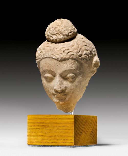 A STUCCO BUDDHA HEAD. Gandhara, 4th/5th c. Height15 cm. Mounted on a wood stand.