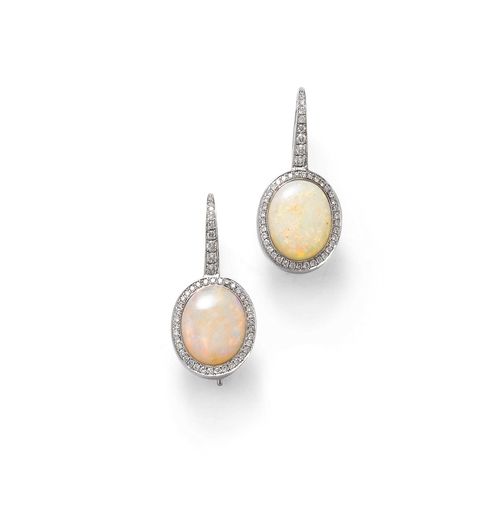 OPAL EAR PENDANTS. White gold 750. Attractive ear pendants, each of 1 oval opal, weighing ca. 5.90 ct in total. The setting and the bow set with 92 brilliant-cut diamonds weighing ca. 0.40 ct in total.