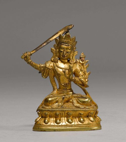 MINIATURE FIGURE OF MANJUSHRI.Sino-Tibetan, 19th/20th c. H 8 cm. Gold lacquered bronze. The compassionate Bodhisattva of Wisdom wields his sword and bears his books on a lotus flower.