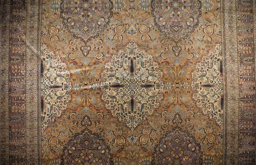 CHORASSAN antique, signed.Beige ground, finely patterned with brown and white medallions, the entire carpet is opulently decorated with plants and birds in delicate pastel colours, wide border in brown and turquoise with flowers and trees, good condition, 690x480 cm.