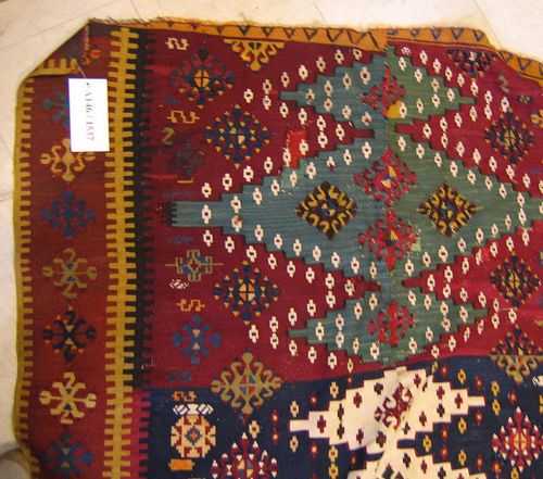 KILIM antique.Red and blue central field, geometrically patterned with lozenges and stars, brown border, ends shortened on both sides, signs of wear, 190x120 cm.