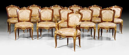 SET OF 12 CHAIRS,2 with armrests, Louis XV style, in the style of F. LINKE (Francois Linke, 1855-1946), Paris. Mahogany veneer. Exceptionally fine, matte and polished gilt bronze mounts and applications. Golden yellow silk covers with flowers and leaves. Fauteuils 65x50x53x98 cm, Chairs 60x50x53x98 cm.