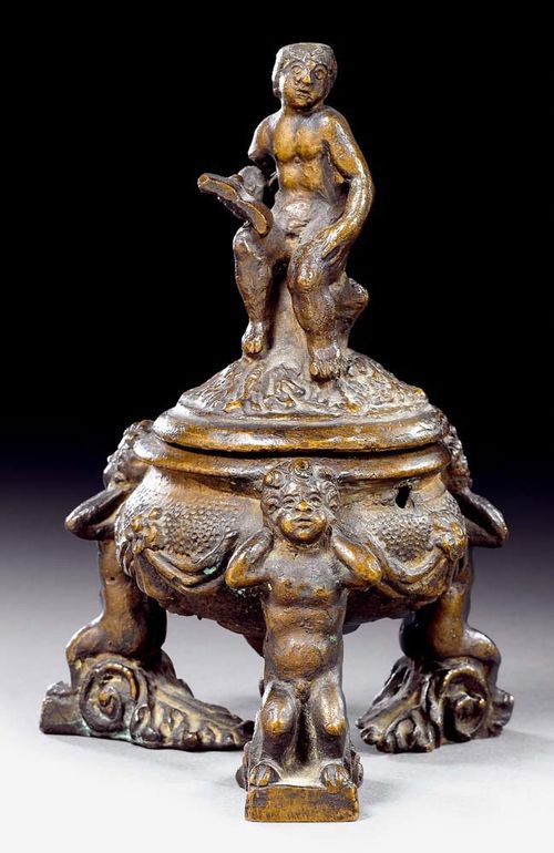 SMALL VESSEL WITH LID,Renaissance, Northern Italy, 17th century Burnished bronze. Round bowl decorated with drapery and flowers, the lid with figure of man reading, set on 3 caryatid supports. Some wear. H 19 cm. Provenance: Private collection, Basel.