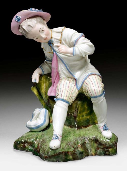RESTING BOY, Hoechst, circa 1770.Model by J.P. Melchior. Underglaze blue wheel mark. H 14.5cm. Repaired and chips.