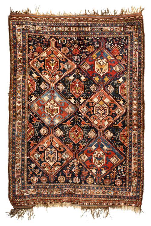 GASHGAI antique.Dark blue ground with 6 medallions. The entire carpet is geometrically patterned with plants and animals, narrow border, good condition, 136x192 cm.