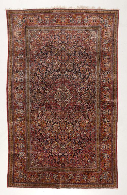KESHAN SILK antique.Opulently patterned central field with trailing flowers and palmettes in attractive pastel colours, red and white central medallion, red border, good condition, 126x210 cm.