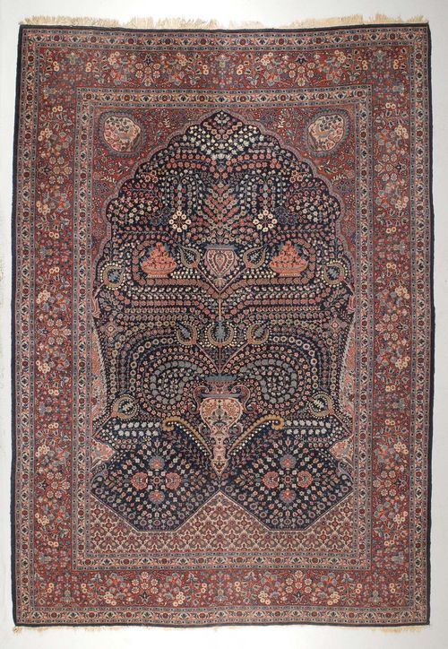 KIRMAN old.Blue central field with plant motifs in harmonious colours, red border, signs of wear, 230x325 cm.