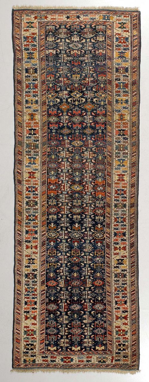 SHIRVAN antique.Blue ground, geometrically patterned with stylised plant motifs, white border with stars, good condition, 95x285 cm.