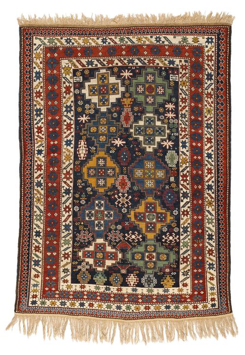 TSCHITSCHI SHIRVAN antique.Blue central field with cross-shaped medallions, geometrically patterned with star motifs, wide border in white and red, signs of wear, 130x180 cm.