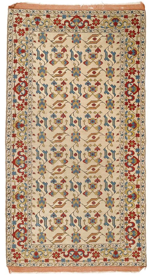 TUDUK old.White ground, patterned throughout with stylised trailing flowers in blue, yellow and red, beige trim, signs of wear, 145x270 cm.