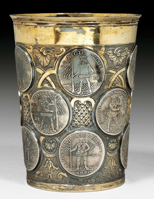 BEAKER WITH COINS. Berlin, mid 18th century.Maker's mark Carl Ludwig Selcke. Marien-Grosch coins inserted in the gilt and richly decorated sides as well as on the bottom. H: 14 cm. Wt.: 420 g.