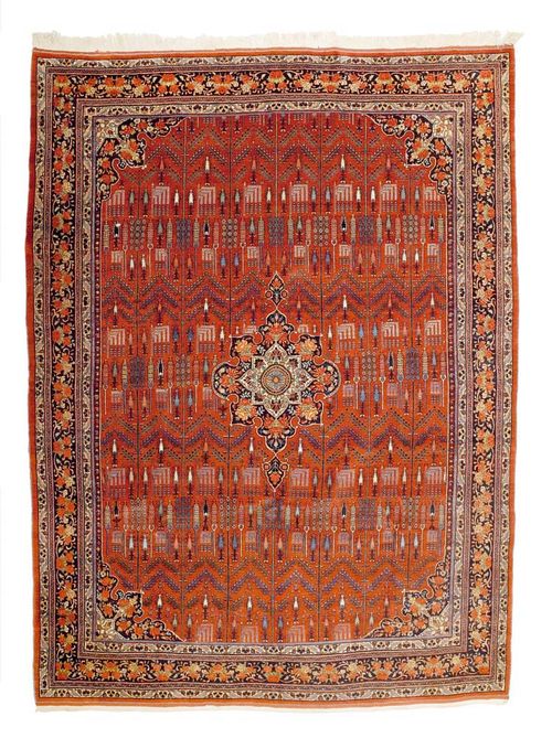 BIDJAR ca. 1930.Red central field patterned with stylised plants and trees in green and beige, with dark border with roses. Good condition, 374x272 cm.