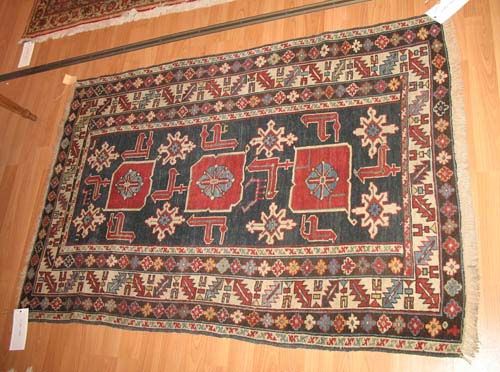 SMALL SHIRVAN antique.Blue central field with three red medallions and white stars. Slightly shortened on both sides, otherwise good condition, 124 x83 cm.